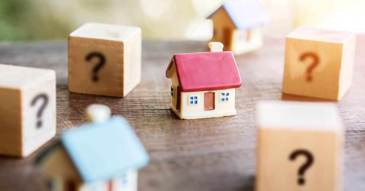 miniature homes with question marks suggesting to ask the right questions when viewing a home for sale